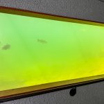 Buhl ID 28 A large rectangular window in a textured wall reveals an underwater view with cloudy greenish-yellow water and a few faintly visible fish swimming.